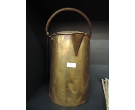 A vintage brass tea can