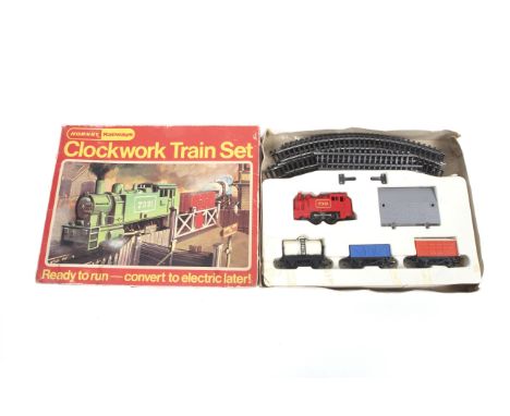 A Hornby railways clockwork train set. Comprising 0-4-0 tank engine, three goods wagons plus track, boxed. 