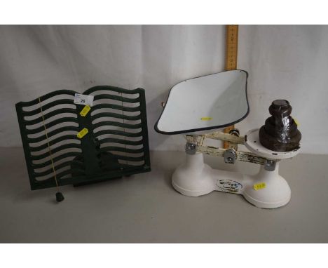 A set of white enamel finish kitchen scales and a cast iron book stand