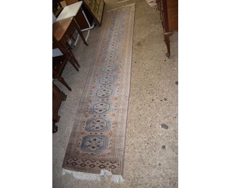 A modern machine made runner carpet with light blue lozenges to centre