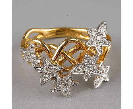 An 18ct gold and diamond dress ring, the intertwined shank applied with six stars set with round brilliant-cut diamonds, esti