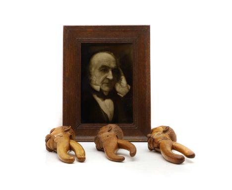A craved hardwood figural nutcracker 19th century, modelled as the head of Otto Von Bismark21.5cm hightogether with two other