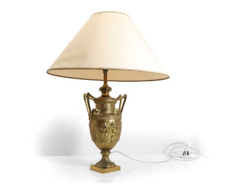 A classical style cast urn table lamp, 20th century, with a conical paper shade, 77cm high overall