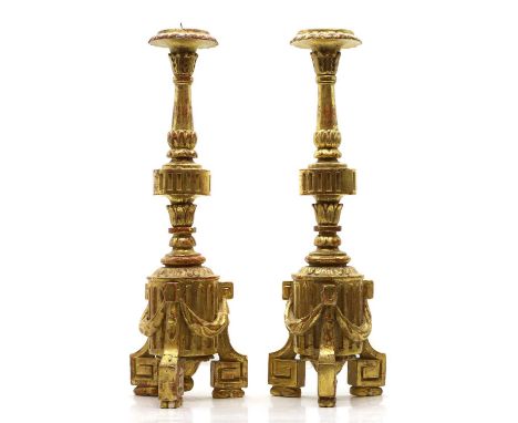 A pair of gilt gesso pricket sticks, late 18th to early 19th century, of tapering form with a fluted column decorated with sw