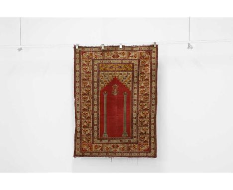 A Persian prayer rug, with central mihrab to a red ground with buff borders, 162 x 121cmCondition ReportWear to pile and fadi