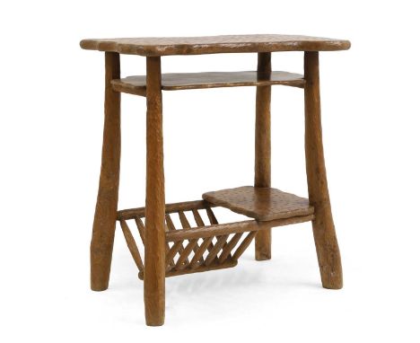 An ash side table second half of the 20th century, French, the adzed top over a shelf and spindle magazine rack,83.5cm wide55