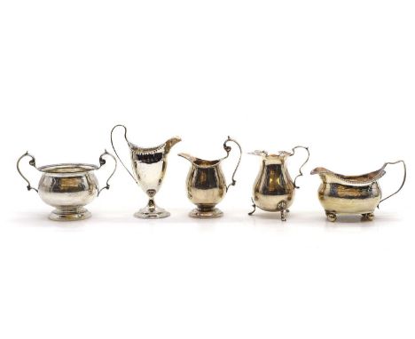 A collection of silver cream jugs to include a George III example, makers mark rubbed, 1787, 14cm high, and a example by Thom