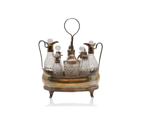 A George III silver eight bottle glass cruet set by Peter, Ann &amp; William Bateman, London 1800, of navette form, with reed