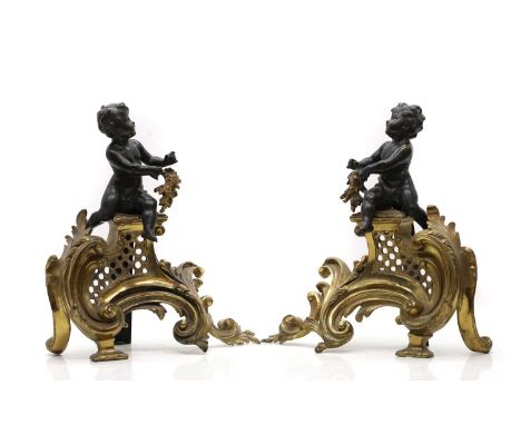 A pair of Louis XV style chenets, late 19th century, modelled with bronze putti,30cm high (2)Condition ReportKnocks, wear, an