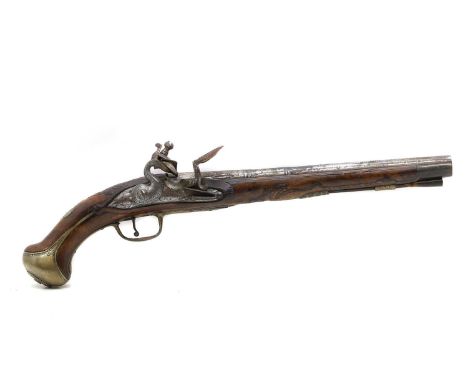 A flintlock pistol 18th century, the leaf engraved lock indistinctly signed, the foliate carved walnut stock with brass mount
