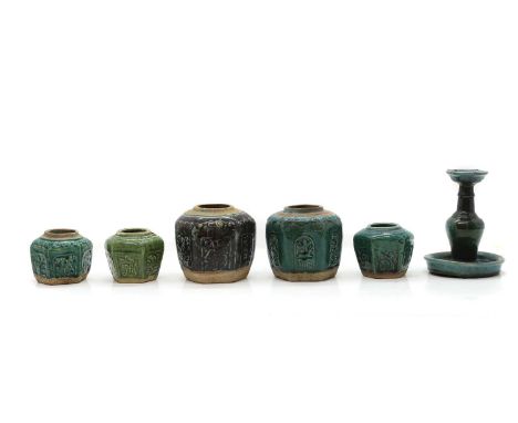 A collection of Chinese Shiwan ware, 19th-20th century, comprising five hexagonal jars and a candlestick, all covered with a 