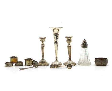 A silver candlestick in the George I style. Birmingham 1969 15.5cm high, together with one other silver candlestick, a spill 