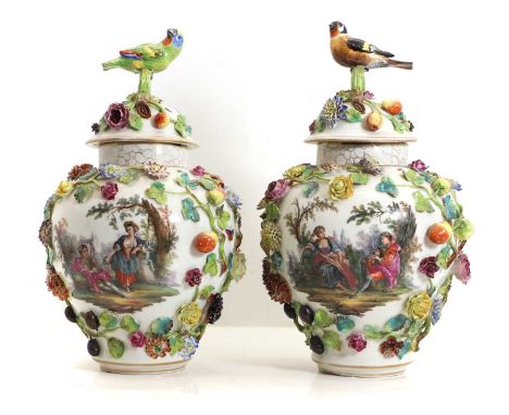 A pair of Dresden type porcelain urns and covers, 19th century, each with floral encrusted decoration, underglaze marks,42cm 