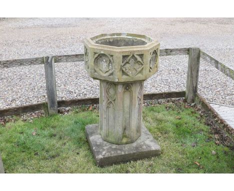 A Victorian carved sandstone font in the Gothic taste, dated 1840, of octagonal form with relief-carved detail, inscribed 'gi