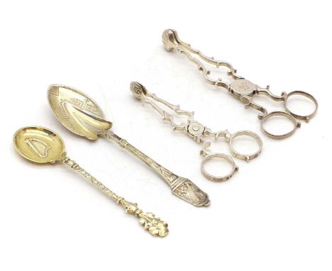 Two pairs of silver sugar nips, by T.N, marks rubbed, 12.4cm and by Wakely &amp; Wheeler, London 1953, 10cm long, together wi