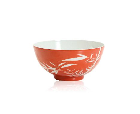 A Chinese coral-ground bowl,  20th century, the body with deep rounded sides covered in coral-red enamel decorated in reserve