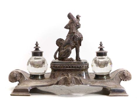 A silver-plated Egyptian Revival desk stand, 19th century, centred with a sphynx, flanked with cut glass inkwells,39cm wide24
