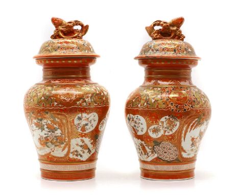 A pair of kutani porcelain vases and covers Meiji (1868-1912) Japanese, the covers with moulded finials in the form of carps,