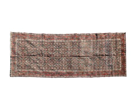 A Hamadan wool runner, first half of the 20th century, the field woven with repeating Mina Khani motifs to a rust ground, wit