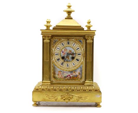 A bronze and porcelain mantel clock, 19th century, the two-train movement striking on a gong, complete with key and pendulum,