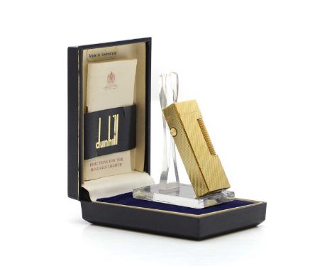 A Dunhill Rollagas gold plated lighter with instructions and case, the case stamped 'Ref DU 72/105Condition ReportGood overal