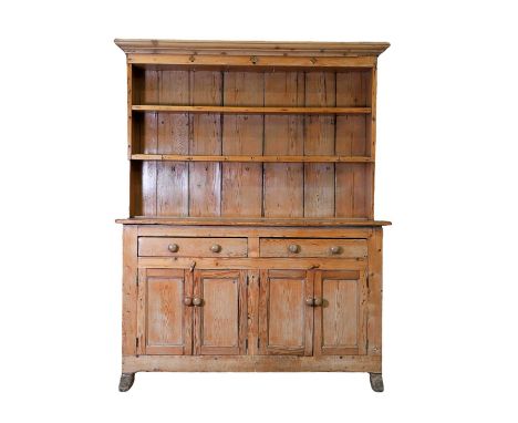 A pine dresser, 19th century, with a boarded back, with two shelves, over two drawers and a pair of cupboards, on sledge supp