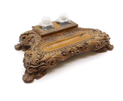 A brass letter rack, 19th century, with pierced foliate decoration, stamped 'DEVAN' to the underside,34cm wideand carved desk
