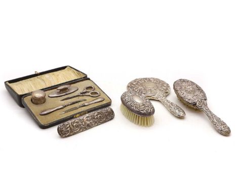A silver dressing table set Birmingham 1978having embossed scrolling leaf decorationtogether with a cased silver manicure set
