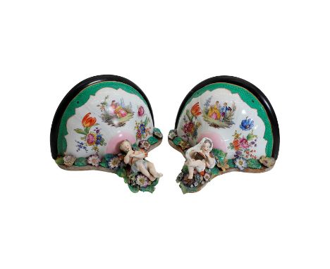 A pair of porcelain mounted brackets, 19th century, in the manner of Meissen, with floral encrusted decoration,27.5cm wide24c
