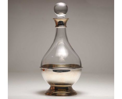 A modern silver mounted decanter,  with a clear glass body, mounted in a silver bowl stand,  30.5cm high  Condition Reportin 