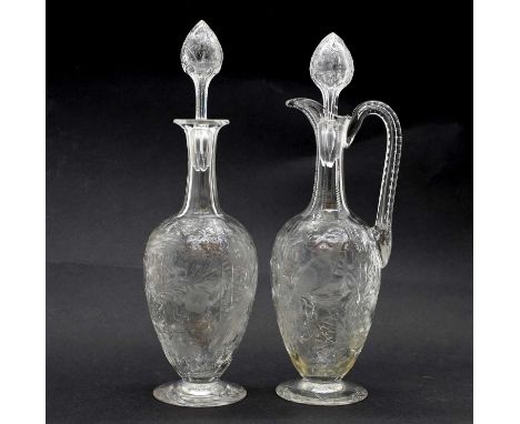 A pair of Stevens & William intaglio cut glass decanters c.1890, Stourbridge, each of ovoid form below slender neck, one with