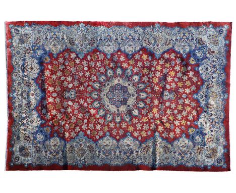 A Najafabaad wool carpet,  20th century, woven with scrolling floral and foliate motifs to a red ground,  385 x 275cm 