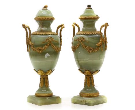 A pair of gilt metal mounted onyx urn table lamps, 20th century, each with ribbon tied swag decoration,36.5cm high (2)Conditi