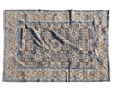 A Keshan wool carpet, 20th century, Persian, the field centred with a chequerboard design, with scrolling Shah Abbasi motifs 
