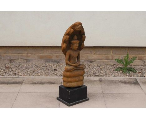 A Bayan style stone carving, on an ebonised plinth, 78cm high