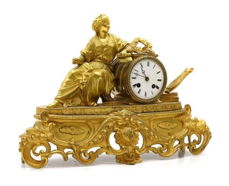A French gilt metal mantle clock 19th centurythe circular enamel dial with robbed woman seated beside, on scrollwork base43cm