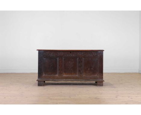 An oak coffer, late 17th/ early 18th century, the plank top over three panels, the centre inscribed '1695' and 'FSL(?)' below