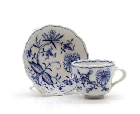 A Meissen onion pattern cup and saucer late 19th century, with underglazed cross swords,6cm high (2)Condition ReportNo appare