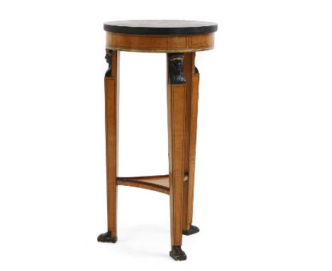 An Empire style satinwood and ebonised gueridon, 20th century, French, the circular top above three tapering supports with Eg