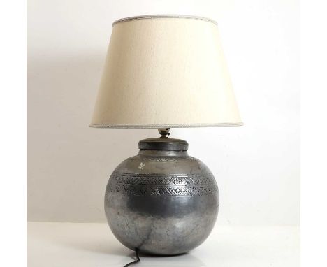 A polished nickel lamp circa 1980s, Indian, probably retailed by Liberty, with spot hammered decoration,29cm high to terminal