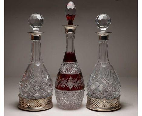 A pair of silver-mounted decanters, 32.5cm high, a pair of pierced silver coasters, 12.8cm diameter, and a silver-mounted rub