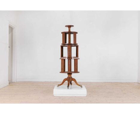 A George III-style satinwood and marquetry revolving bookcase, late 19th century, in the Sheraton taste, with three independe
