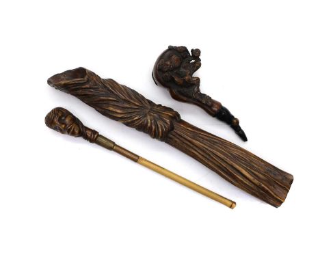 A Chinese rootwood pipe 19th century, carved with a seated figure with foliage,13cm wide,together with a further figural pipe