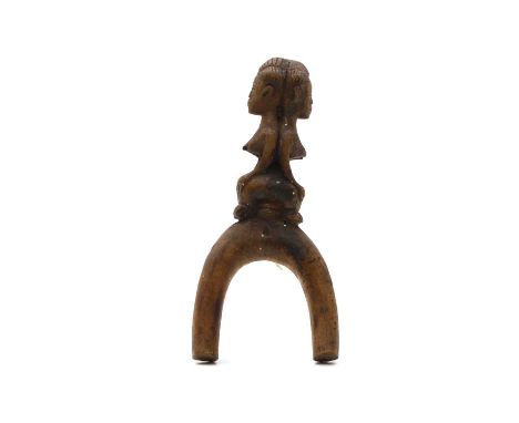 A Janus catapult 20th century, Baule, Ivory Coast, the handle carved with two seated figures,16.8cm highShipping Disclaimer B