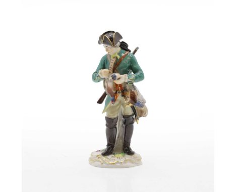 A Meissen figure of a gamekeeper 20th century, Cris de Paris Series, modelled holding two pheasants wearing a green jacket, i