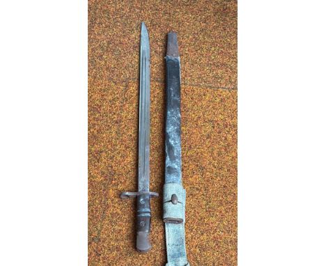 WWI-era military bayonet with scabbard and canvas frog. Steel blade.