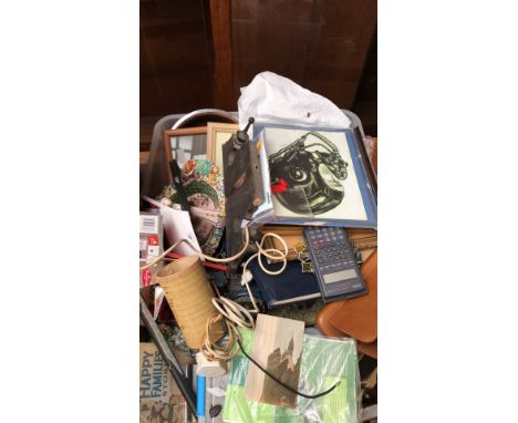 Eclectic mixed lot featuring framed artwork, vintage Casio calculator, decorative stained glass, and books.