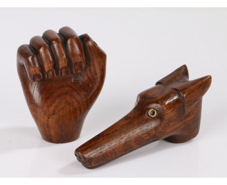 Two carved oak novelty walking stick handles, one in the form of a dogs head, the other in the form of a fist (2)