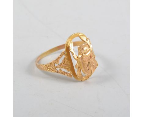 A yellow metal scrab beetle design ring, the brightly cut engraved model of a beetle set on a frame, plain shank with etched 