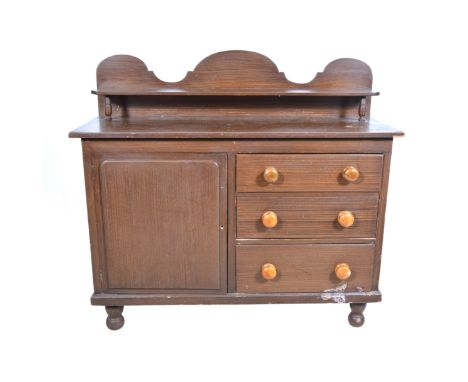 19th Century painted pine kitchen dresser (original grain finish), the shaped back with shallow shelf, turned pulls to the dr